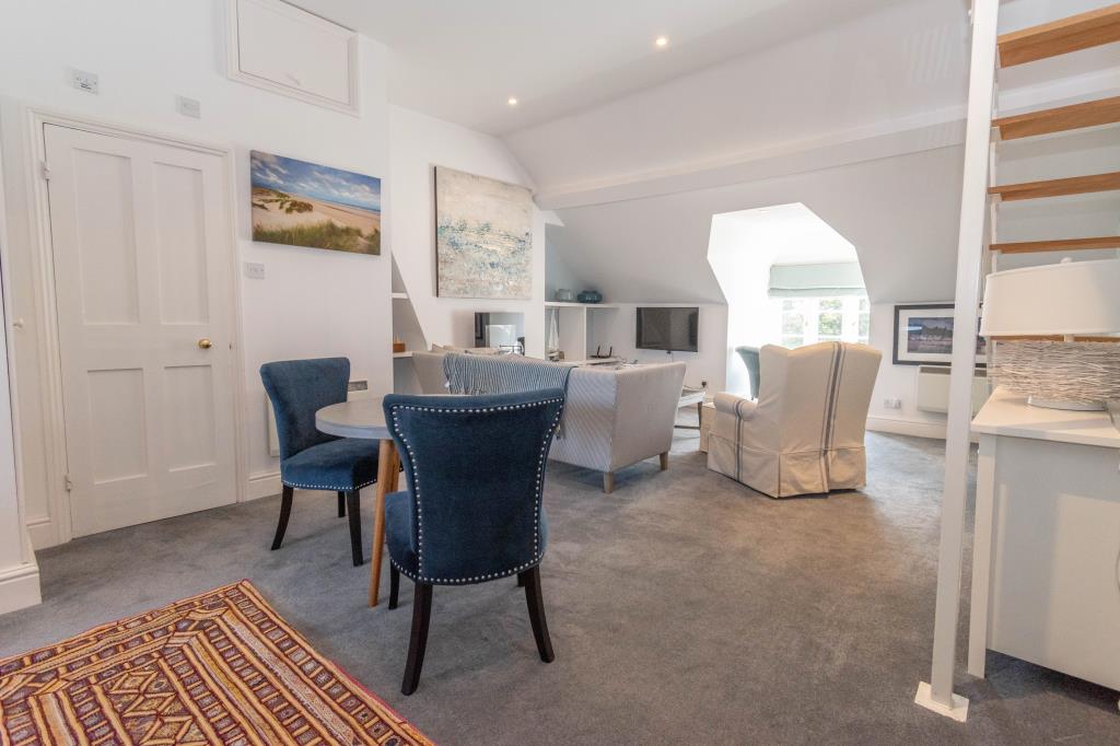 Lot: 29 - CHARACTERFUL FLAT IN A DESIRABLE NORFOLK COASTAL TOWN - Living room from kitchen door window to front and door to shower room